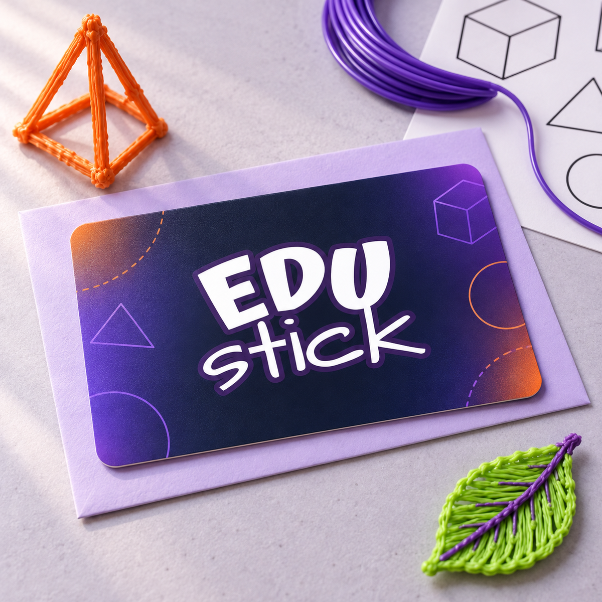 EDUstick® gift card with a central logo, surrounded by colourful 3D pen creations